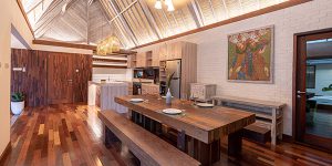 Luxury interior fully crafted from hardwood timber, featuring natural wood walls, floors, and ceiling in a tropical villa