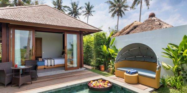 Exclusive Touchwood wooden villas overlooking a luxurious swimming pool in a tropical destination