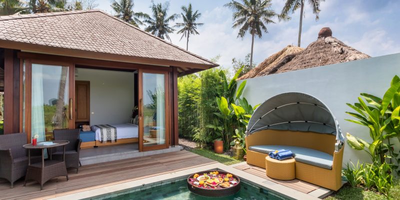 Exclusive Touchwood wooden villas overlooking a luxurious swimming pool in a tropical destination