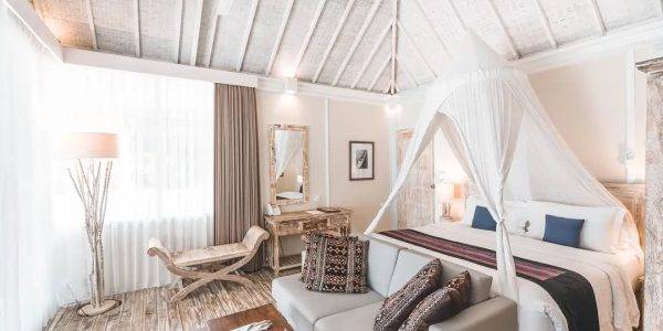 Warm wooden interior with natural lighting and open tropical layout in a Labuan Bajo villa