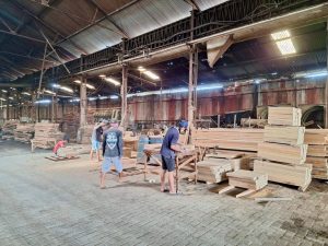 Carpenter working on hardwood beams at Touchwood's Surabaya warehouse