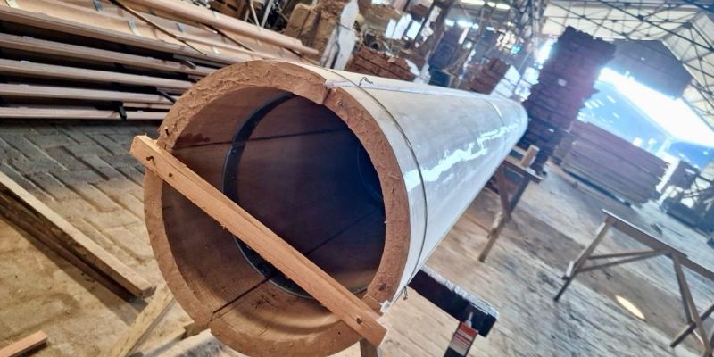 Skilled worker shaping hardwood components for villa structures