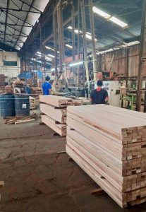 Craftsman sanding wood surface for luxury villa construction