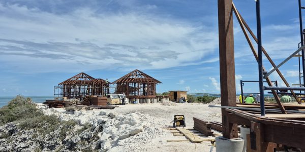 Island resort villa build in progress, elevated above sand and sea breeze