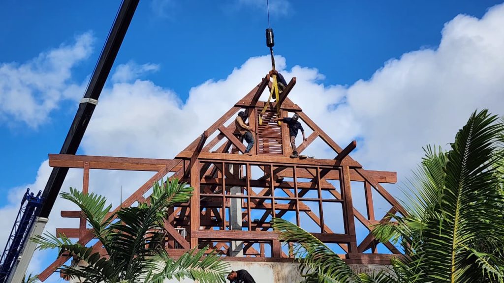Skilled crew from Touchwood working on Merbau wood roof installation in Seychelles