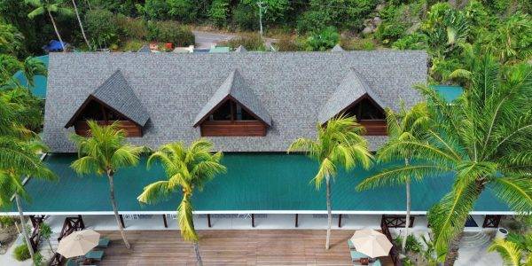 Corner view of the Merbau roof construction at Paradise Sun Hotel’s Main Restaurant in Seychelles, emphasizing durability and luxury design