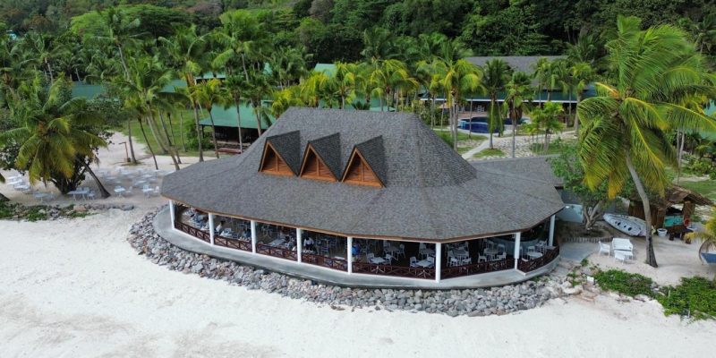 Side angle of the completed Merbau roof structure of the Main Restaurant, Paradise Sun Hotel, showing natural hardwood details and craftsmanship