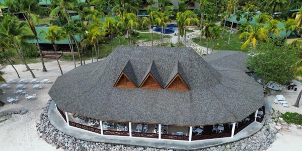 Front view of the finished Merbau wood roofing at the Main Restaurant, Paradise Sun Hotel, Praslin, Seychelles, highlighting the tropical architectural design