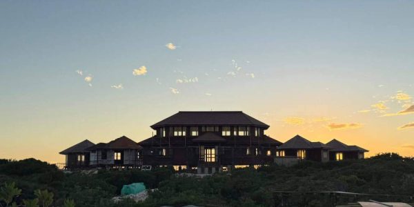 Sunset exterior of a tropical island resort bungalow with Ironwood roof and Merbau structure, highlighting Touchwood’s premium workmanship